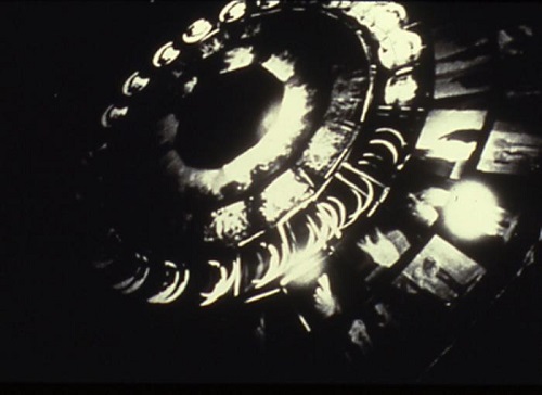Retrospectroscope (1996) by Kerry Laitala, plexiglass disc with silver gelatin transparencies on rotating motor, 5’ diameter disk x 4' height. 
